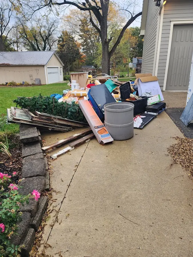 Dumpster being loaded with debris for 12 Yard Dumpster Rental in Logansport